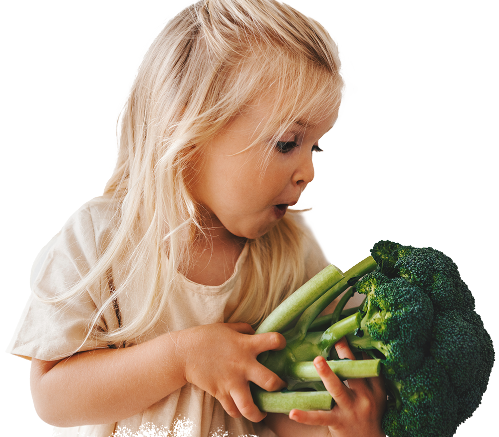 Child holding fresh broccoli for a Chefs Feeding Kids nutrition program