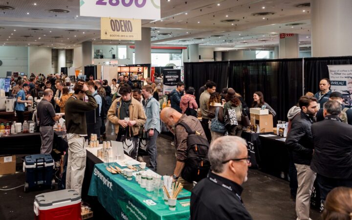 Coffee Fest attendees compare products and suppliers on a busy show floor