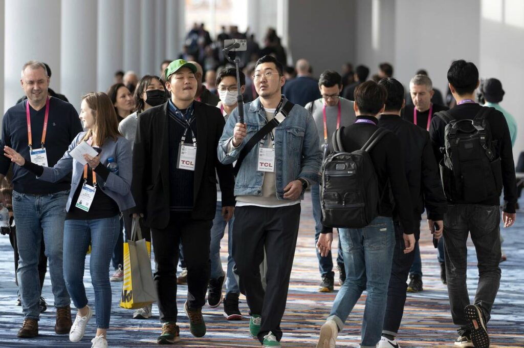 Badged attendees walking the CES concourse