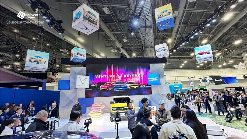 CES exhibit hall with LED screens and vehicle display