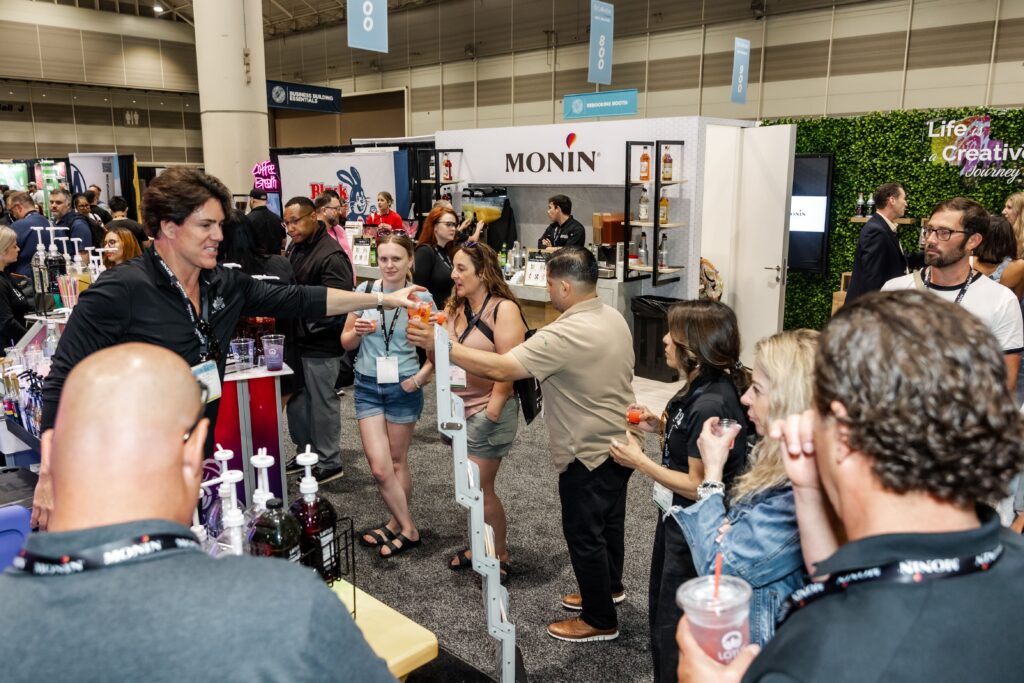 Attendees at exhibitor booths on the Coffee Fest floor