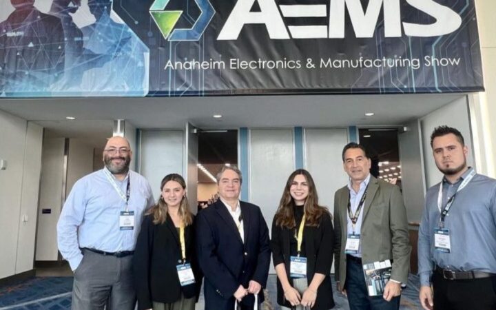 Attendees in front of the Anaheim Electronics show banner