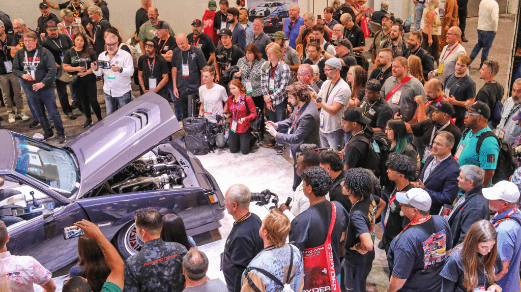 Crowd gathered around a vehicle unveiling at SEMA