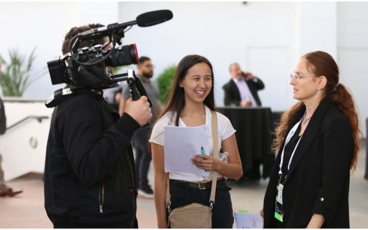 Camera operator filming an interview at the SMPTE Summit
