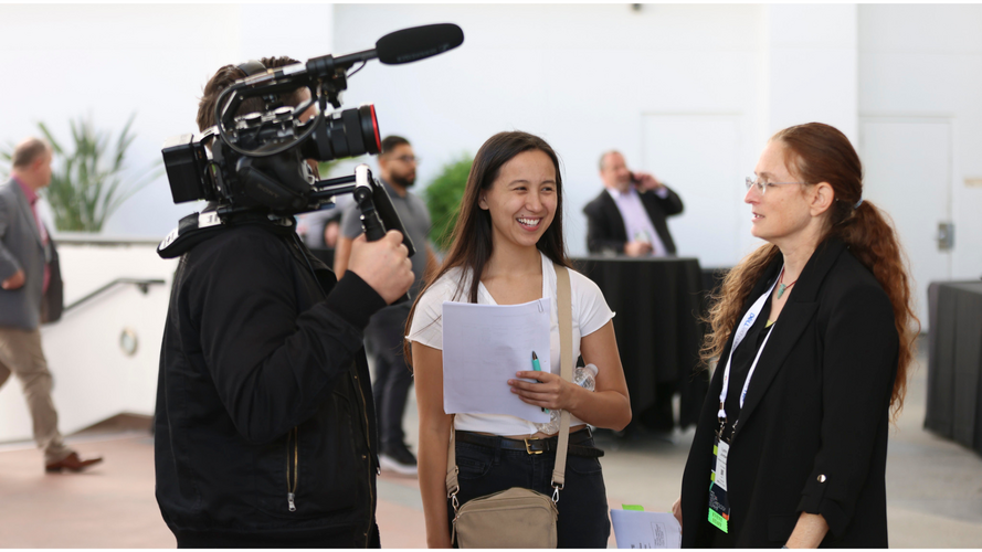 Camera operator filming an interview at the SMPTE Summit