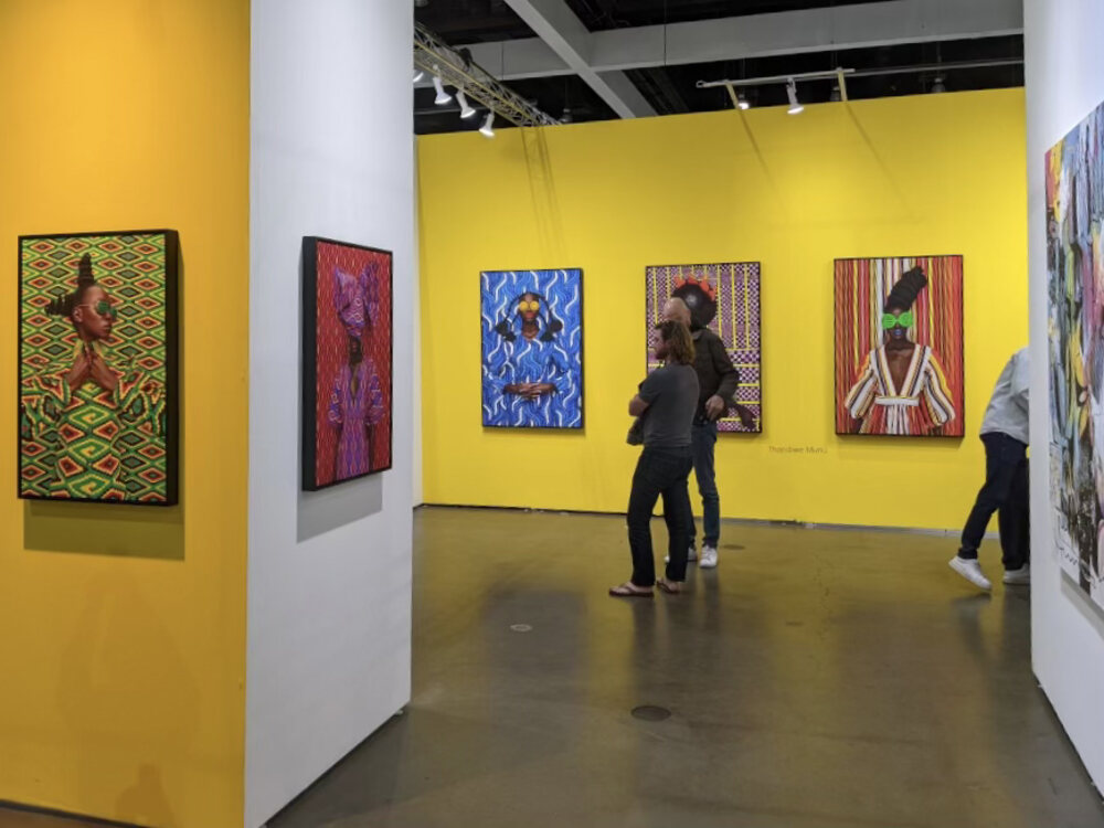 Visitors in a gallery booth at the LA Art Show
