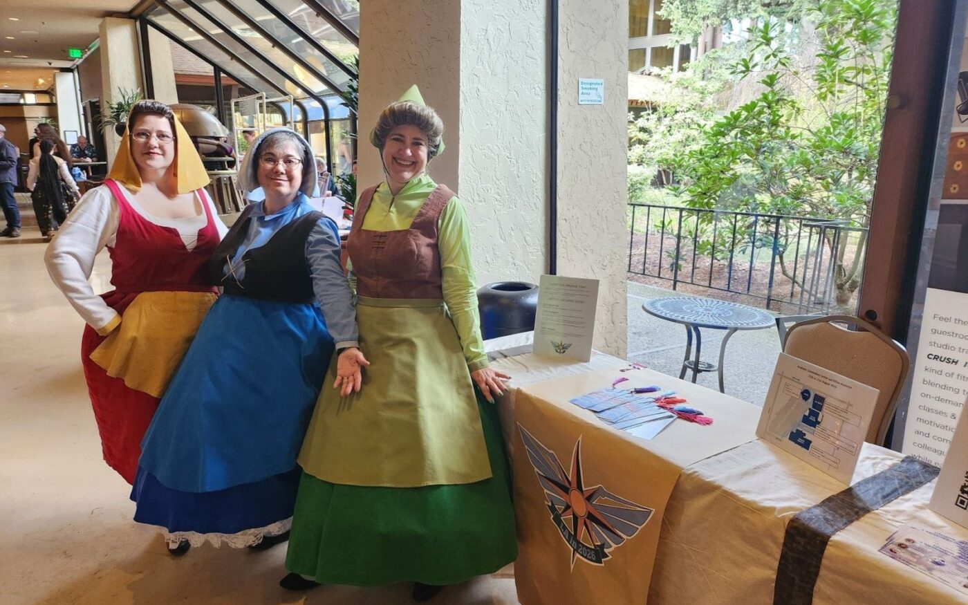 Costumed attendees at a fan table