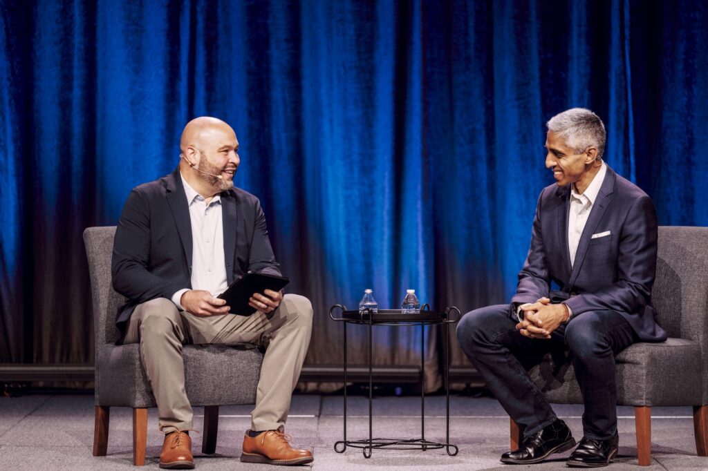 Two speakers in a fireside chat on stage