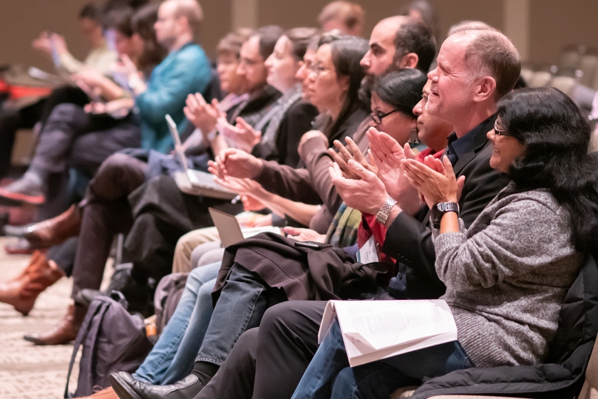 Audience applauding at an MLA session