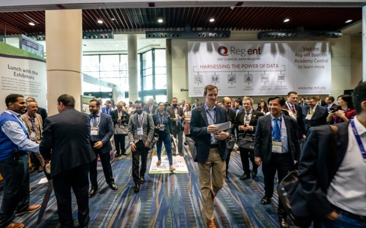 Attendees in the OTO EXPO exhibit hall concourse