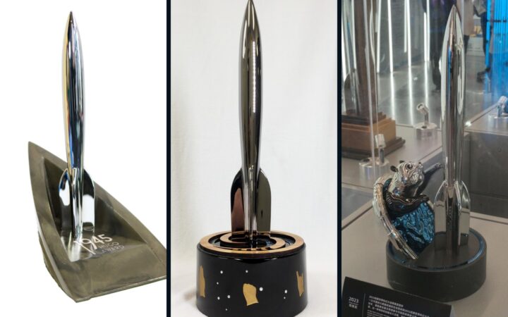 Three Hugo Award trophies from different Worldcon years