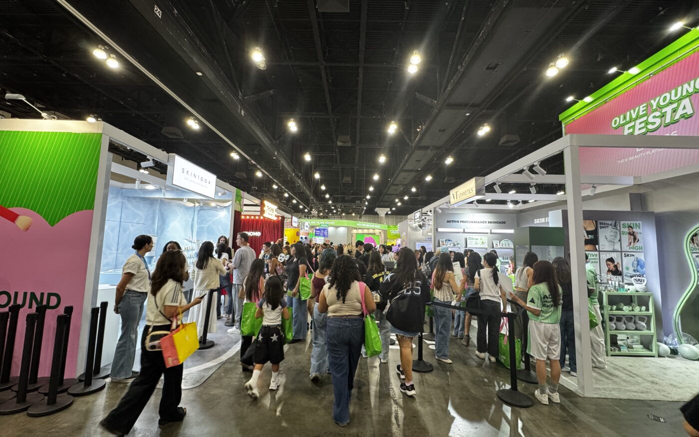 A busy aisle of themed K-beauty booths inside Olive Young Festa LA 2026