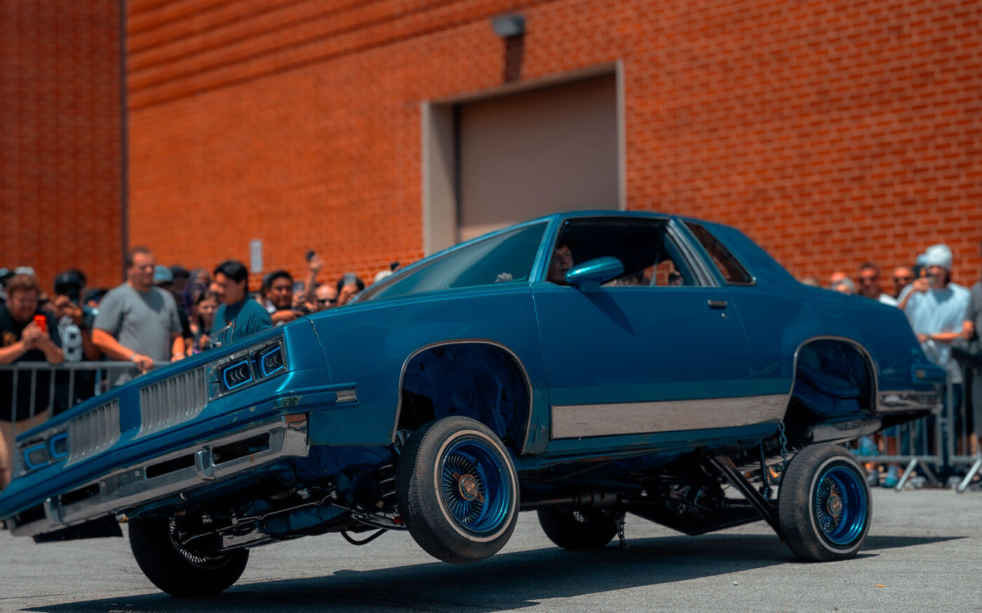 Lowrider lifting its front wheels during a live show demonstration