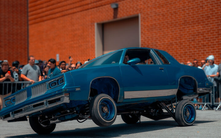 Lowrider lifting its front wheels during a live show demonstration
