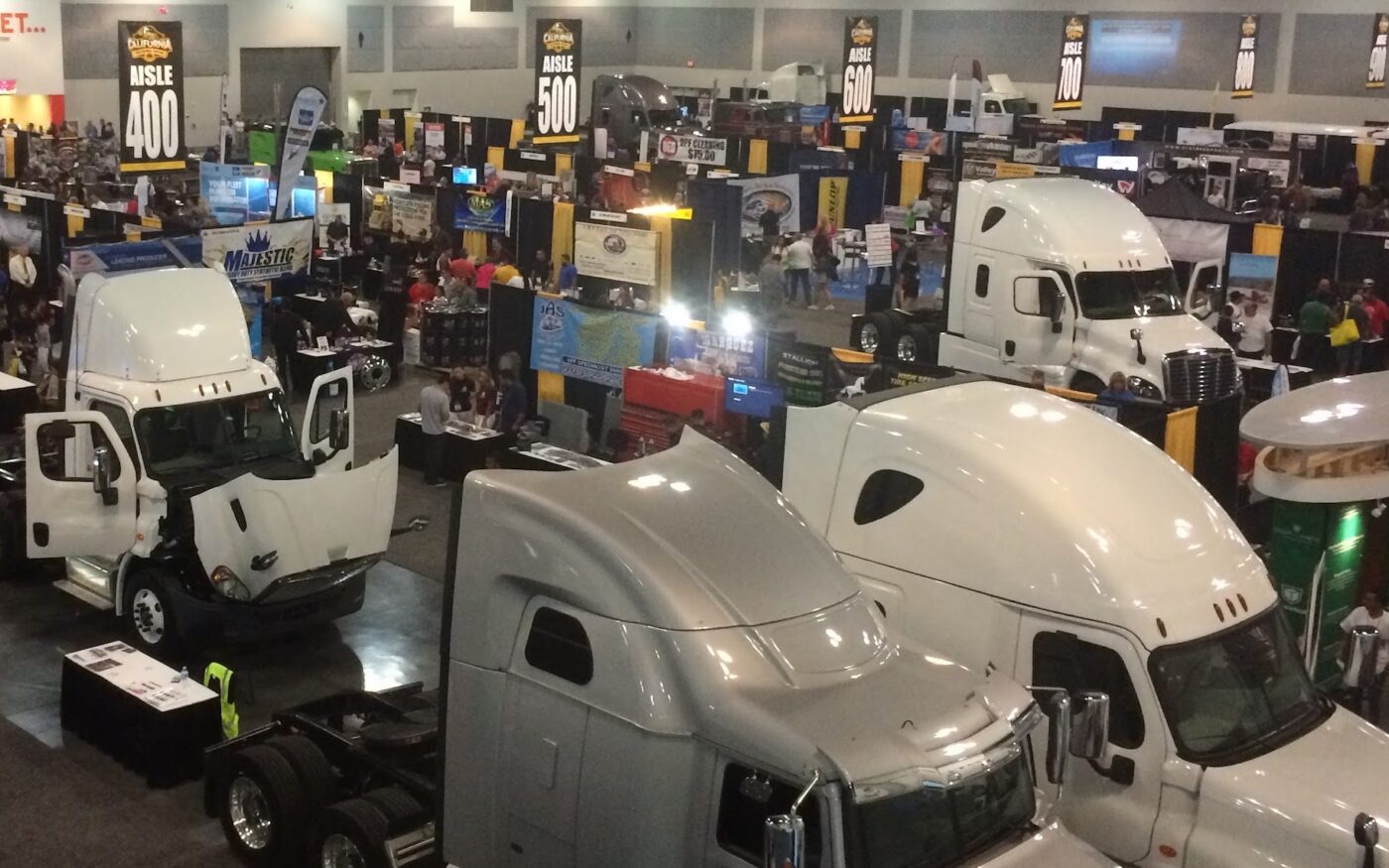 Heavy-duty trucks and exhibitor booths at the California Trucking Show
