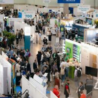 Greenbuild expo hall with sustainability exhibitors and attendees