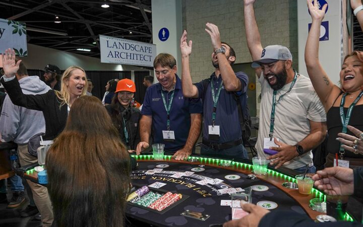 Landscape professionals gather around a product demonstration at The Landscape Expo