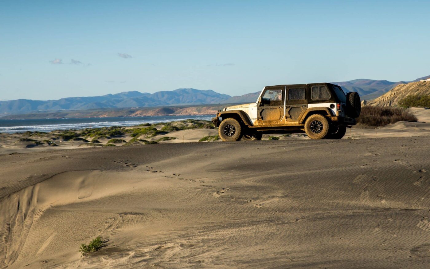 Off-road Jeep on sand dunes near the California coast